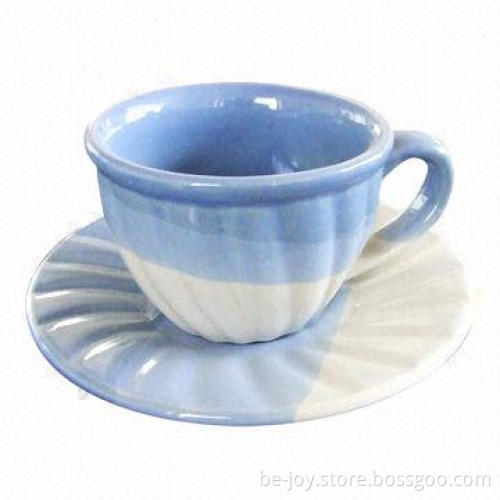 Stoneware cup and saucer, various artworks are available